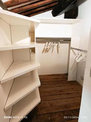 a closet with white shelves and a ceiling at Torretta Luxury Attico in Rome