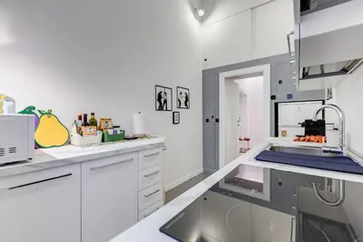 a kitchen with white cabinets and a sink at InTheMoodForRome - Musei Vaticani in Rome
