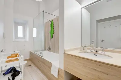 a bathroom with a sink and a tub and a mirror at InTheMoodForRome - Musei Vaticani in Rome
