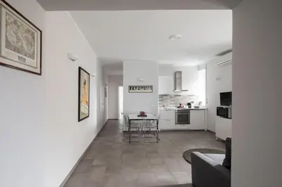 a living room with a table and a kitchen at Nice and spacious apartment near the Vatican and Starbucks in Rome