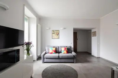a living room with a couch and a television at Nice and spacious apartment near the Vatican and Starbucks in Rome