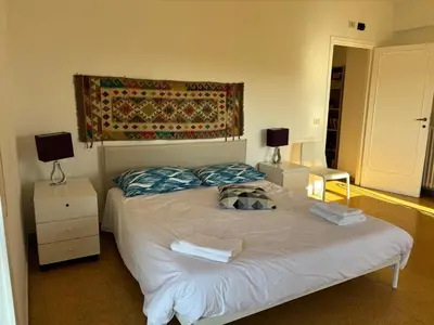a bedroom with a bed with two night stands and two lamps at Conca d'Oro 212 in Rome