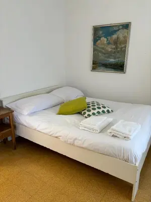 a bed with two towels and a picture on the wall at Conca d'Oro 212 in Rome