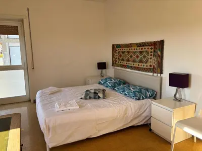 a bedroom with a bed and a table with a lamp at Conca d'Oro 212 in Rome