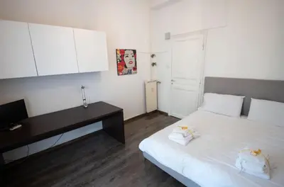 a bedroom with a bed with a desk and a computer at Domus Collazia - San Giovanni Apartment in Rome
