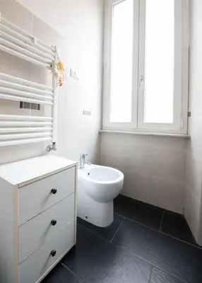 a bathroom with a sink and a toilet and a window at Domus Collazia - San Giovanni Apartment in Rome