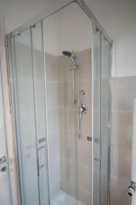 a shower with a glass door in a bathroom at Domus Collazia - San Giovanni Apartment in Rome