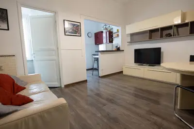 a living room with a white couch and a television at Domus Collazia - San Giovanni Apartment in Rome