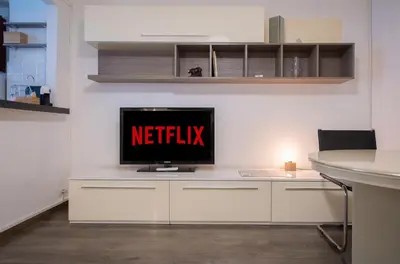 a desk with a television with the netflix sign on it at Domus Collazia - San Giovanni Apartment in Rome
