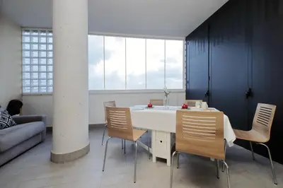 a dining room with a white table and chairs at Annasole's flat by Domus&Dimore in Rome