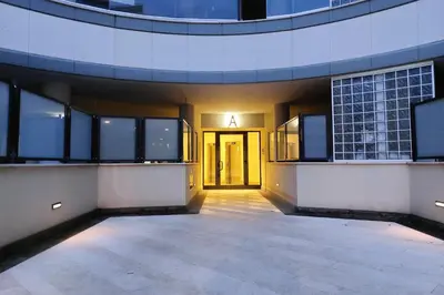 an empty courtyard of a building with a glass door at Annasole's flat by Domus&Dimore in Rome