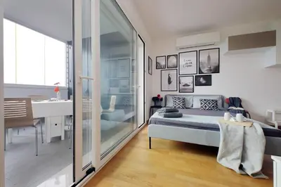a bedroom with a bed and a bathroom with a sink at Annasole's flat by Domus&Dimore in Rome