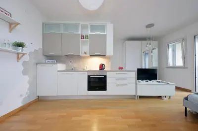a kitchen with white cabinets and a stove at Annasole's flat by Domus&Dimore in Rome