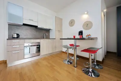 a kitchen with a counter and two bar stools at Claudias flat by DomusDimore in Rome