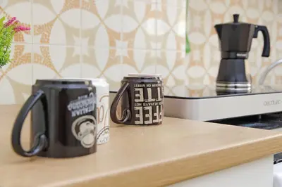 two coffee mugs sitting on top of a counter at Micheles Flat by DomusDimore in Rome
