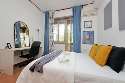 a bedroom with a bed with a desk and a chair at Micheles Flat by DomusDimore in Rome
