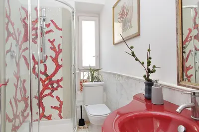 a bathroom with a red sink and a toilet at Piazza Venezia Apartment in Rome