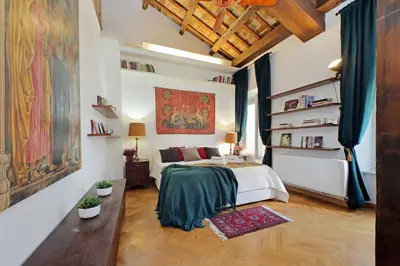 a bedroom with a bed and a painting on the wall at Piazza Venezia Apartment in Rome