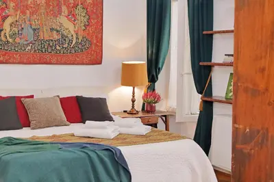 a bedroom with a bed and a painting on the wall at Piazza Venezia Apartment in Rome