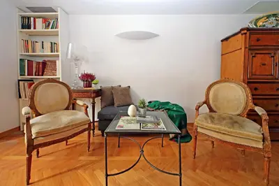 a living room with two chairs and a table at Piazza Venezia Apartment in Rome