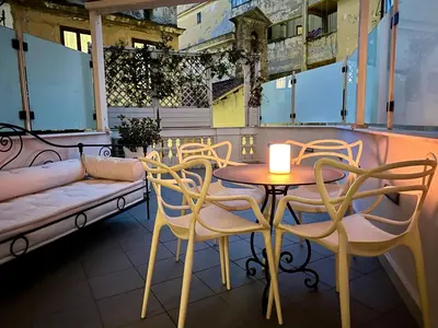 a patio with a table and chairs and a couch at The Terrace Luxury in Rome