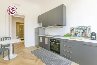 a kitchen with a stove and a table in a room at C M Civitas Leonina Luxury in Rome