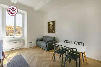 a living room with a table and chairs and a couch at C M Il Passetto di Borgo Pio in Rome