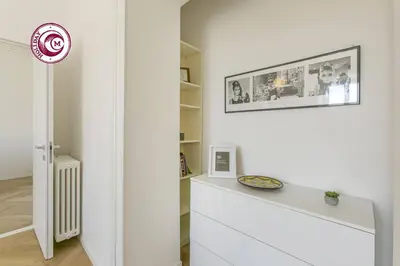 a white room with a white dresser and a shelf at C M Il Passetto di Borgo Pio in Rome