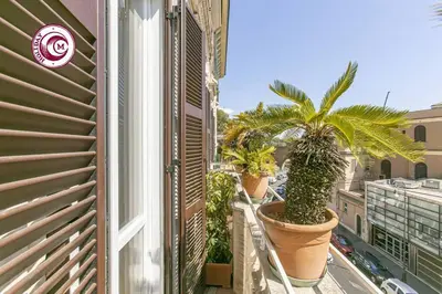 a balcony with palm trees in pots on a building at C M Il Passetto di Borgo Pio in Rome
