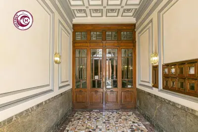 a hallway with a wooden door in a building at C M Il Passetto di Borgo Pio in Rome
