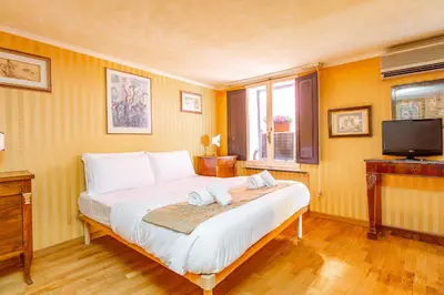 a bedroom with a bed with two towels on it at Easybnb - Bear Home in Rome