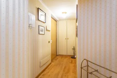 a hallway with a door and a wall with wallpaper at Easybnb - Bear Home in Rome