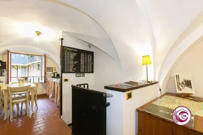 a kitchen and dining room with an arch ceiling at Palazzo Scapucci Apartment a Navona in Rome