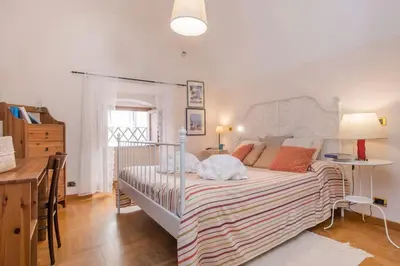 a bedroom with a large bed with a striped blanket at Palazzo Scapucci Apartment a Navona in Rome