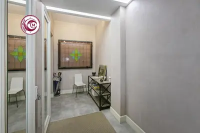 a hallway with a desk and chairs in a room at C M Piazza Cavour Elegant Flat in Rome