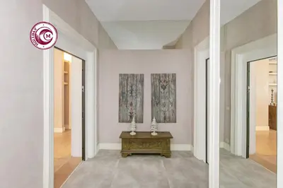 a hallway with a table in the middle of a room at C M Piazza Cavour Elegant Flat in Rome
