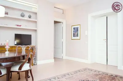 a dining room with a table and a television at C M Piazza Cavour Elegant Flat in Rome