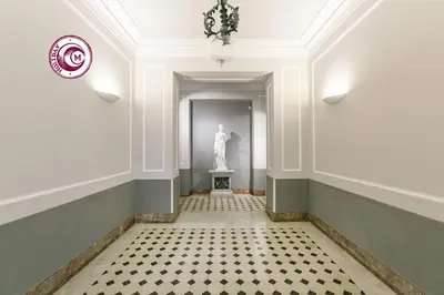 a hallway with a statue in the middle of a room at C M Piazza Cavour Elegant Flat in Rome