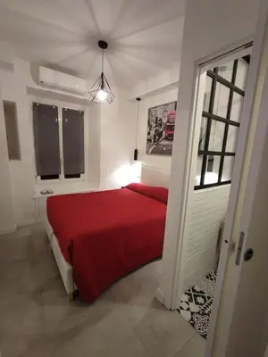 a bedroom with a red bed in a room at SamDom's Home City Station termini Rome in Rome