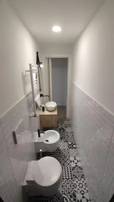 a bathroom with two toilets and a sink at SamDom's Home City Station termini Rome in Rome