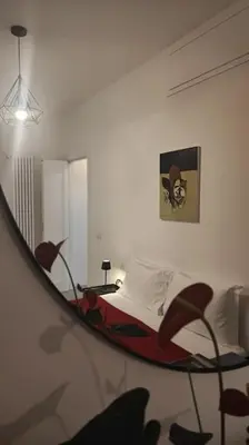 a bedroom with a bed and a mirror at SamDom's Home City Station termini Rome in Rome