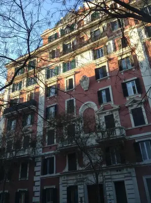 a tall red building with a lot of windows at Nido Degli Angeli in Rome