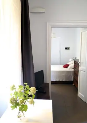 a room with a bedroom with a bed and a mirror at Nido Degli Angeli in Rome