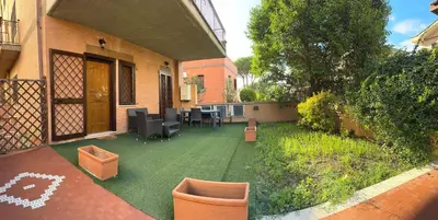 an outdoor patio with a table and chairs on a yard at Casina dei Gemelli in Rome