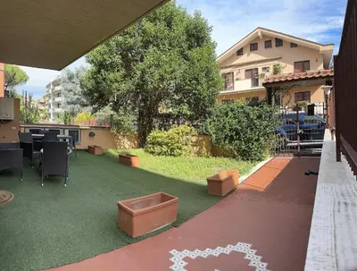 a backyard with a lawn with a table and chairs at Casina dei Gemelli in Rome