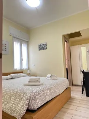 a bedroom with a bed with two towels on it at Casina dei Gemelli in Rome