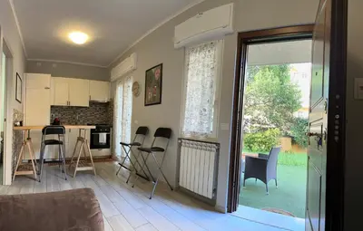 a kitchen with a table and chairs in a room at Casina dei Gemelli in Rome