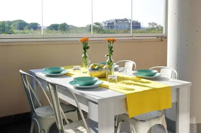 a white table with a yellow table cloth and chairs at Martas flat by DomusDimore in Rome