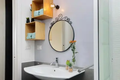 a bathroom with a sink and a mirror at Martas flat by DomusDimore in Rome
