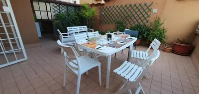 a white table and chairs on a patio at Attico a Gianicolense in Rome